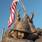 Bronze statue depicting soldiers raising the American flag.