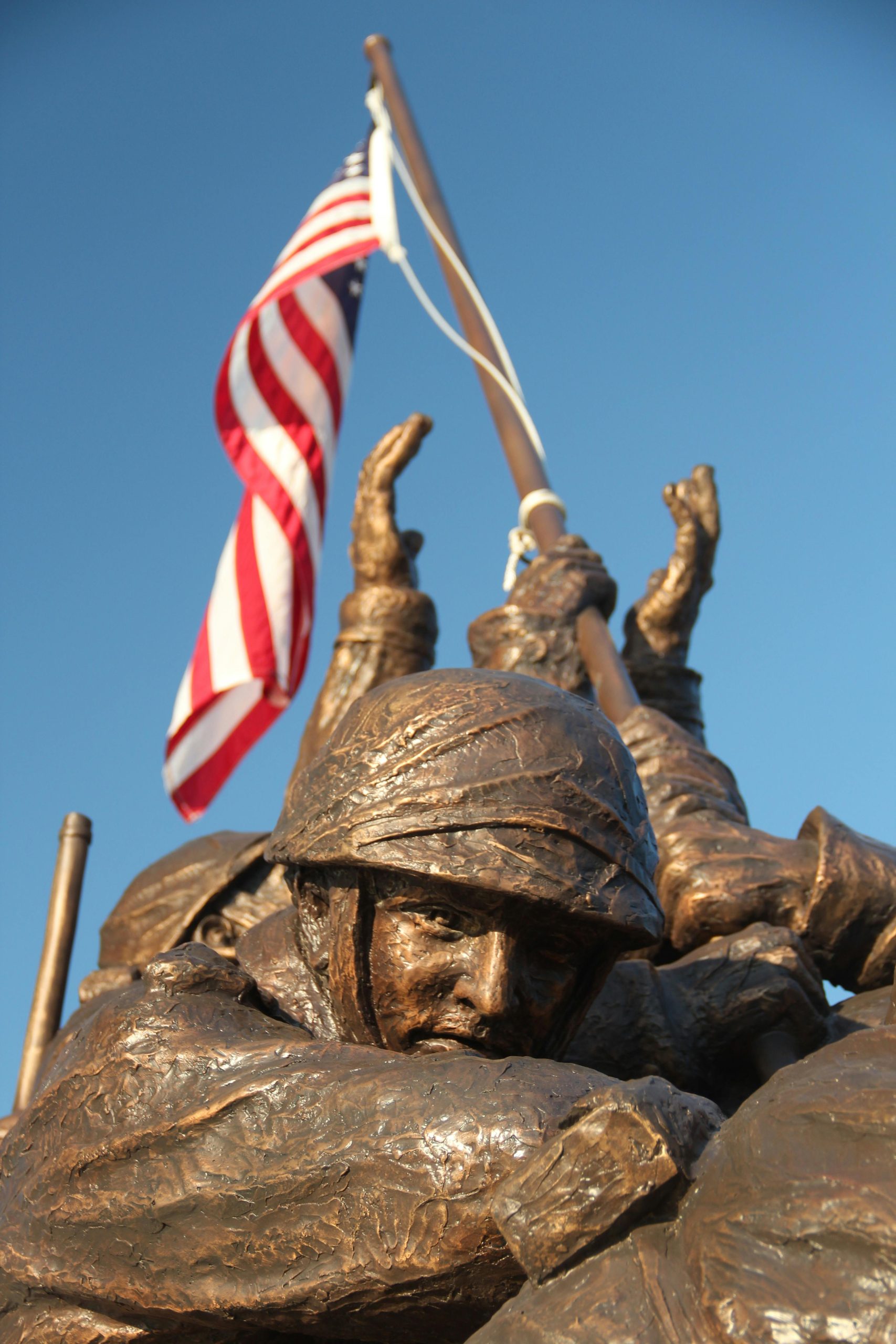 Bronze statue depicting soldiers raising the American flag.